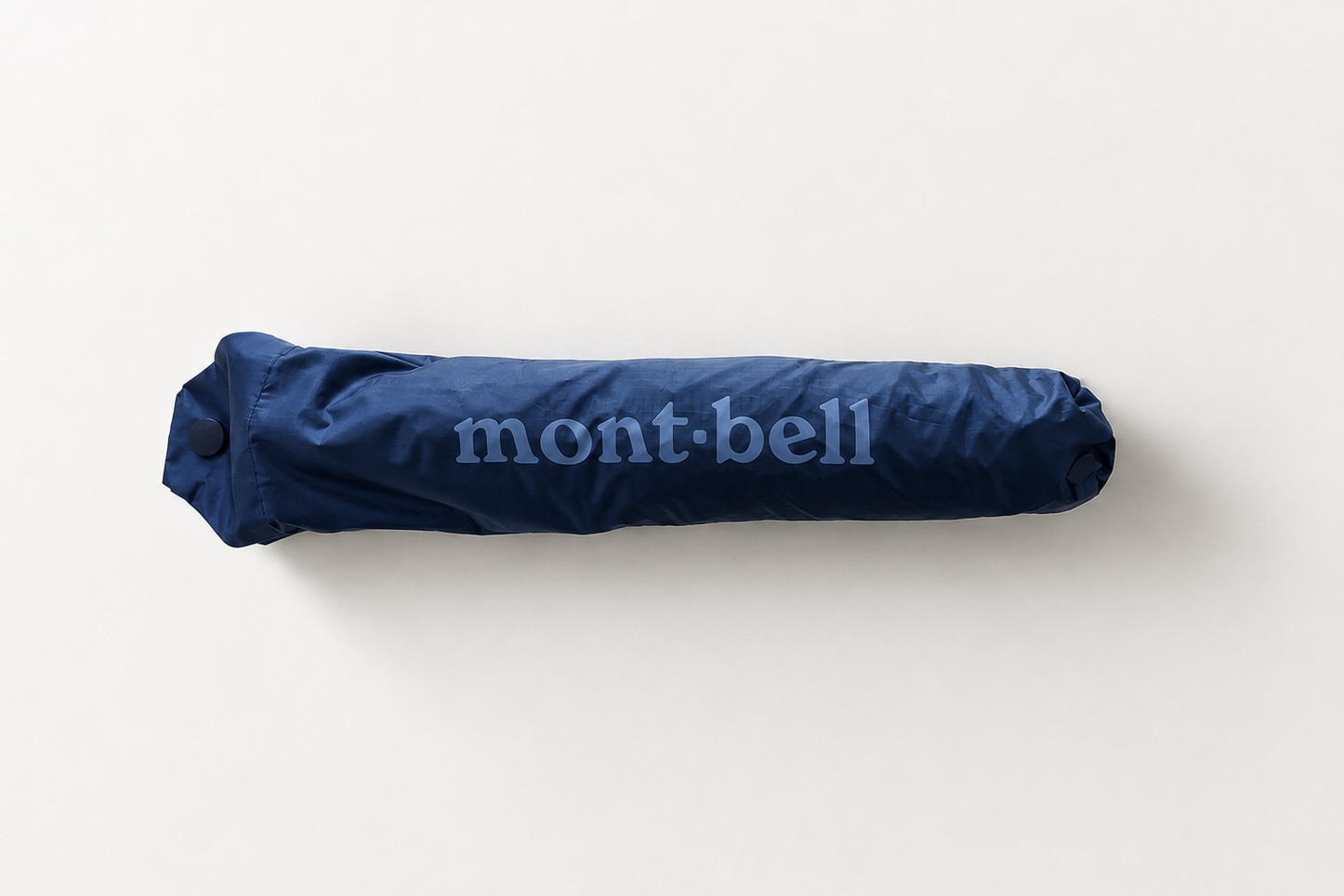 Montbell folding umbrella in its navy storage sleeve