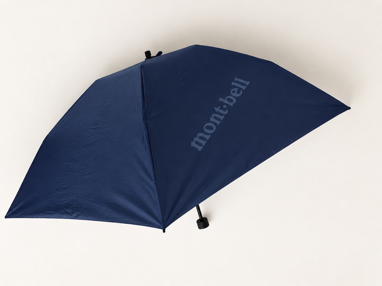 Navy Montbell ultra-light folding umbrella opened