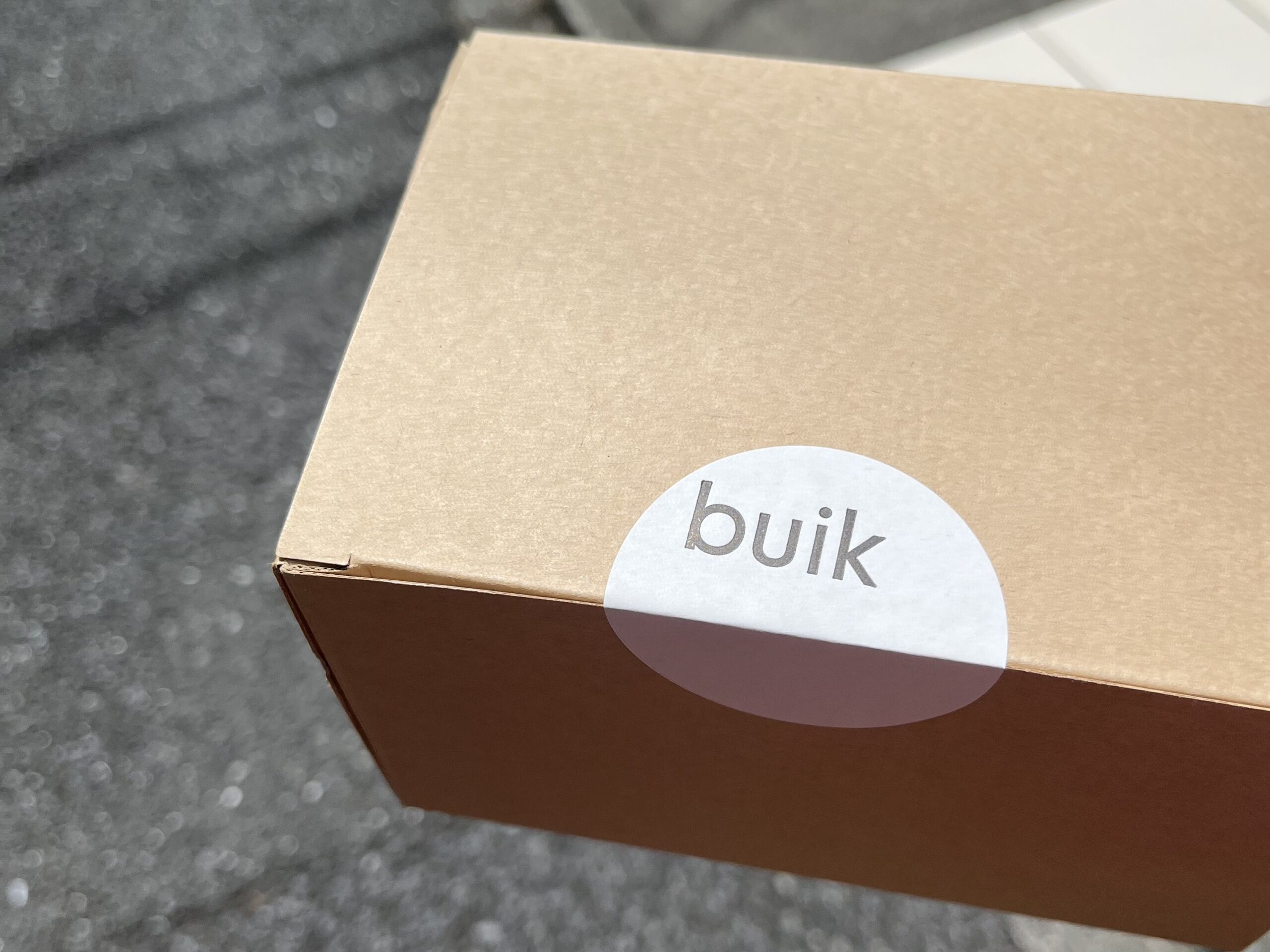 A Buik takeaway box with the cafe logo sticker