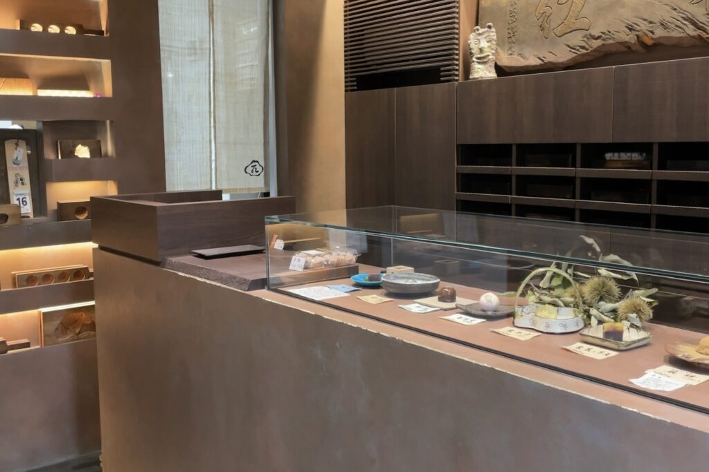 A glass display case of seasonal wagashi at Aoyama Beniya