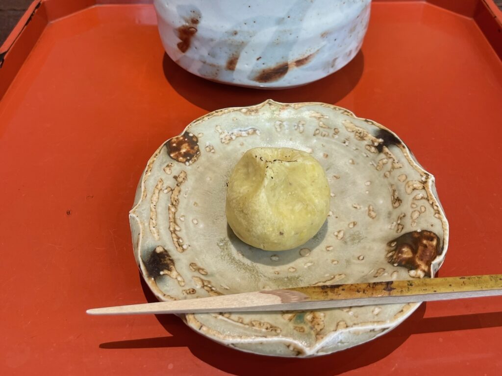A close-up of a chestnut-based seasonal wagashi served at Aoyama Beniya